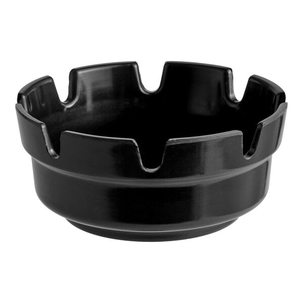 A black plastic ashtray with multiple grooves along the rim.