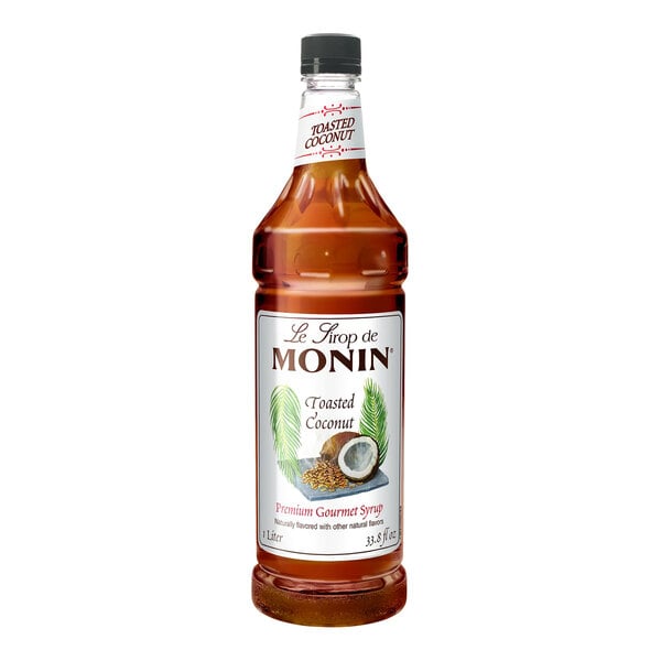 A 1-liter bottle of Monin Premium Toasted Coconut Flavoring Syrup.