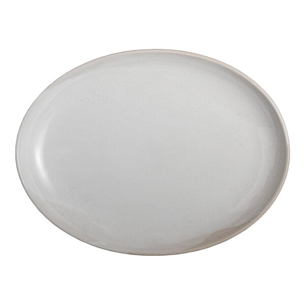 An oval white stoneware platter measuring 12 3/4 by 9 1/2 inches.