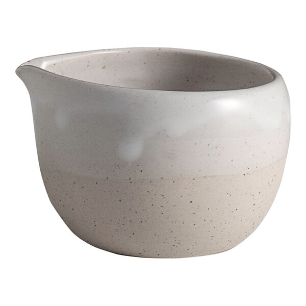 A small round white stoneware spouted ramekin with a two-tone finish.
