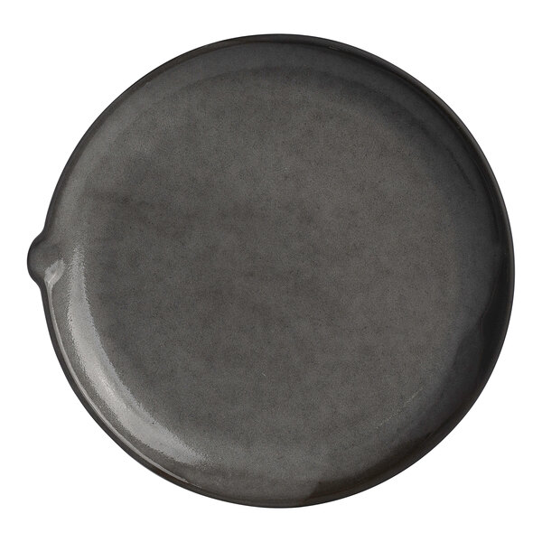 A round gray stoneware plate with a small spout on one side.
