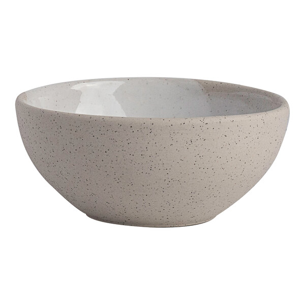 A round white stoneware bowl with a speckled finish.