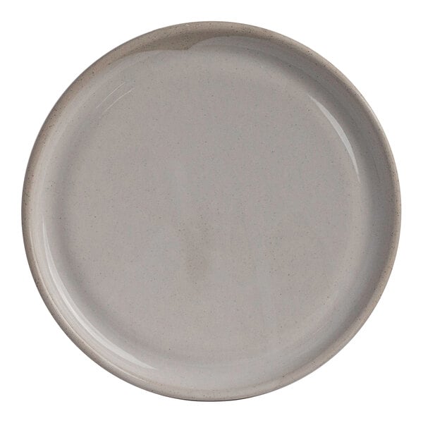 A round white stoneware plate measuring 6 1/2 inches in diameter.