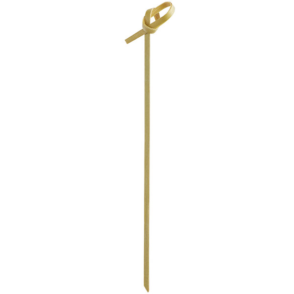 A natural bamboo food pick with a decorative knot at the top.