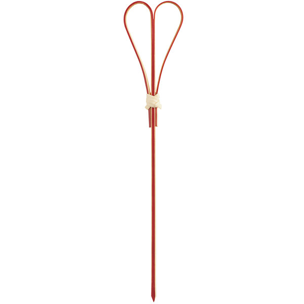 A red bamboo food pick with a heart-shaped top and a pointed end.