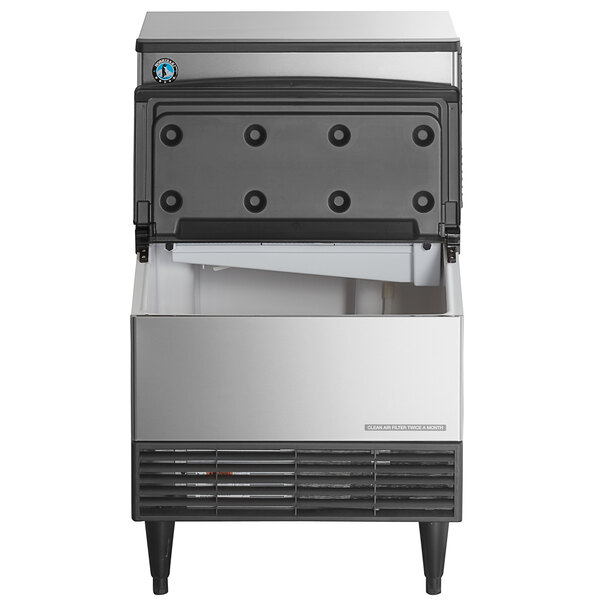 A stainless steel undercounter ice machine with a front-opening storage bin and air vents at the bottom.
