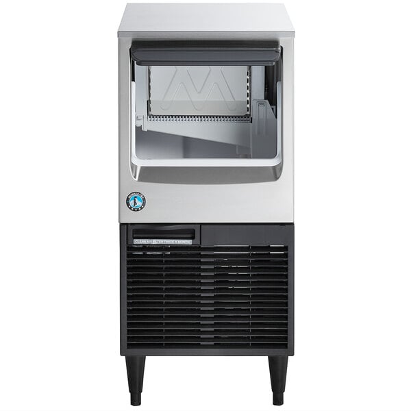 A stainless steel undercounter ice machine with a built-in storage bin.
