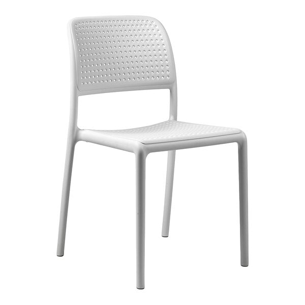 A white resin stackable outdoor chair with a perforated back and seat.