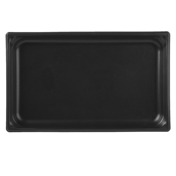 A Vollrath stainless steel rectangular steam table pan with a black SteelCoat finish on a black tray.