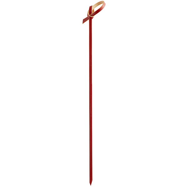 A red bamboo knot food pick or skewer.