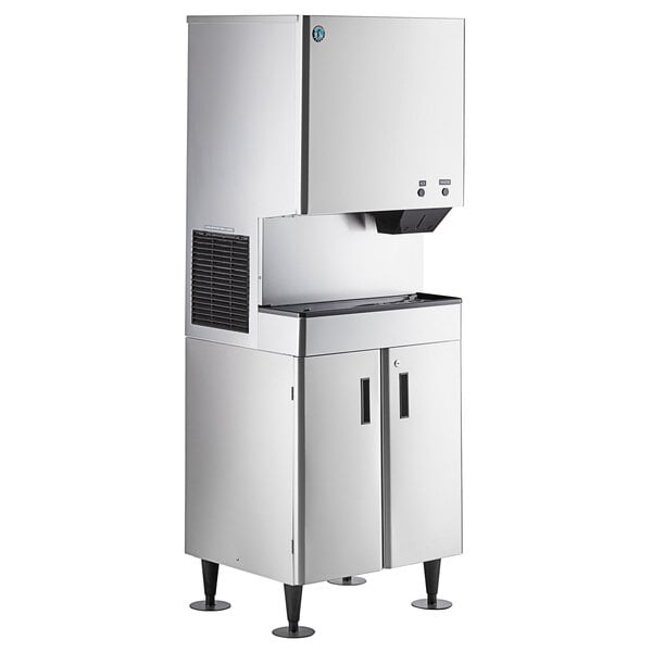 A commercial stainless steel ice maker and water dispenser with a floor stand and built-in storage bin.