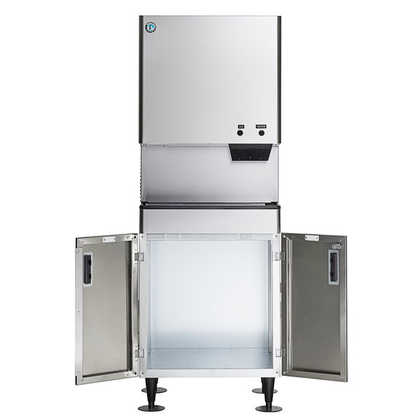 A commercial stainless steel ice maker and water dispenser with an open storage bin and floor stand.