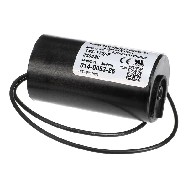 A cylindrical electrical start capacitor with attached wires and a product label.