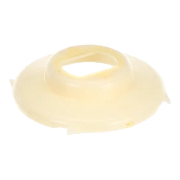 A round, beige plastic water shed component for an Ice-O-Matic machine.