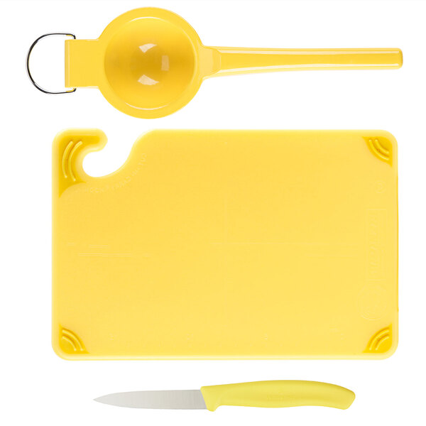 A yellow Saf-T-Grip plastic cutting board with a knife and spoon.