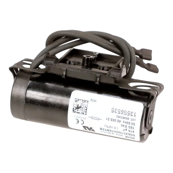 A black cylindrical start capacitor with attached wires, used for Embraco compressors in Delfield refrigeration units.