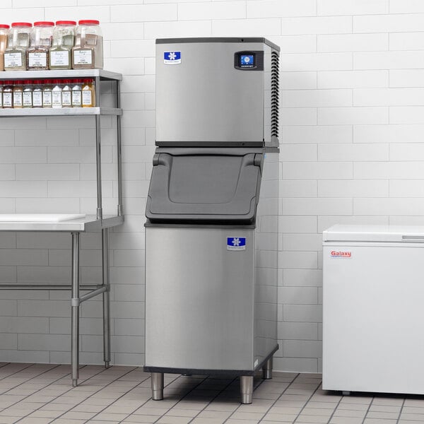A commercial stainless steel ice machine with a storage bin, designed for producing and storing ice cubes.