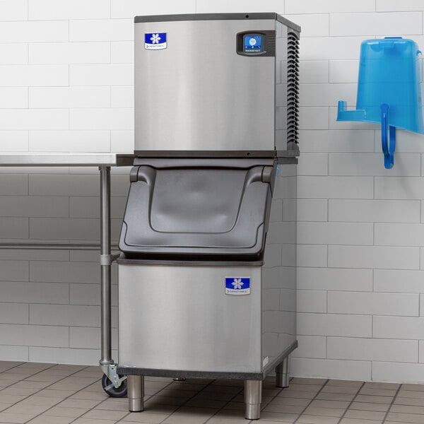 A commercial stainless steel ice machine with a storage bin, designed for producing and storing ice cubes.