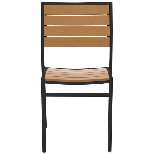 A BFM Seating Largo outdoor side chair with a black frame and synthetic teak wood back.