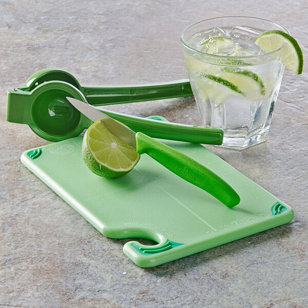 A Saf-T-Grip cutting board with lime wedges and a knife.