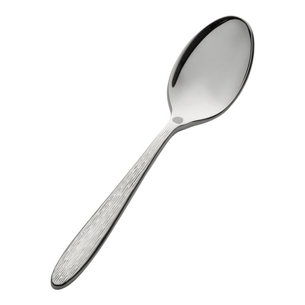 A stainless steel demitasse spoon with a textured handle.