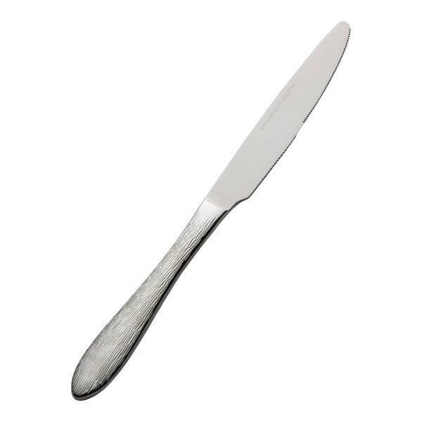 A stainless steel dinner knife with a textured handle.