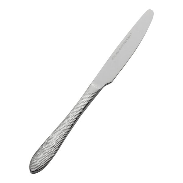 A stainless steel butter knife with a textured handle.