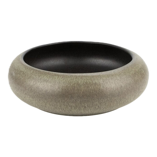 A round green and brown stoneware bowl with a wide rim and a dark interior.