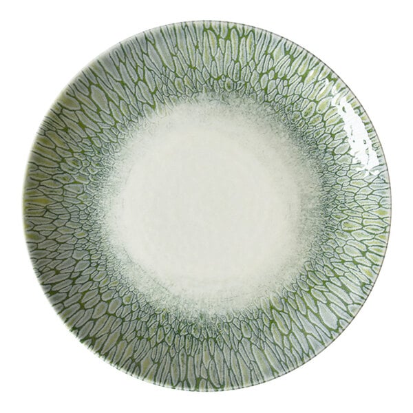 A round green and white china bowl with a textured, patterned rim.