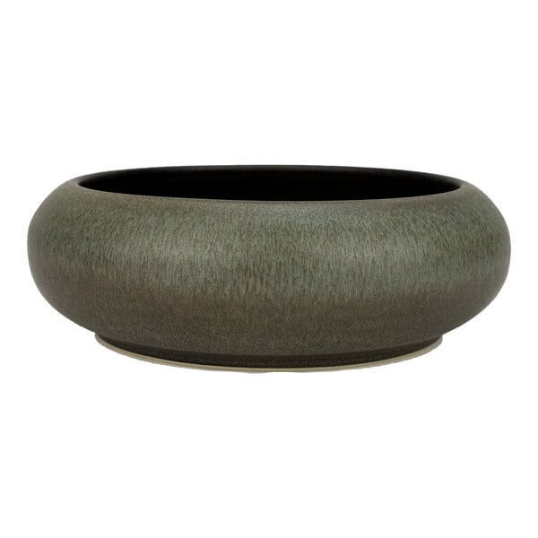 A round, green and brown stoneware bowl with a wide, low profile.