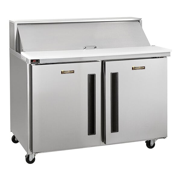 A stainless steel two-door refrigerated sandwich prep table with a raised ingredient rail and cutting board.