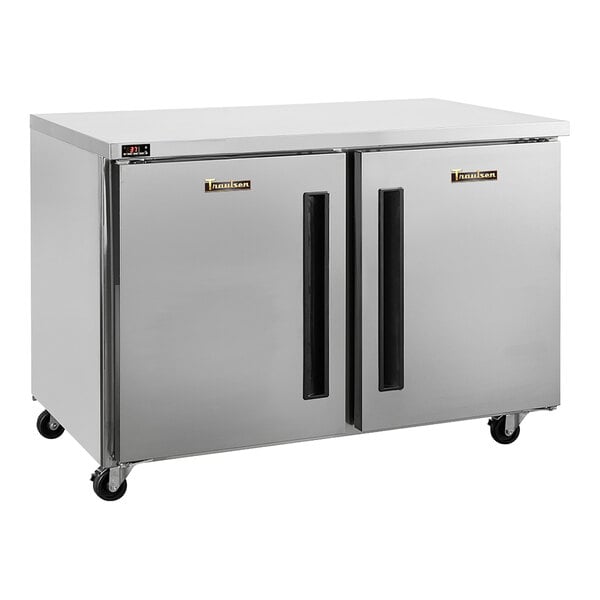 A stainless steel undercounter freezer with two doors and caster wheels.