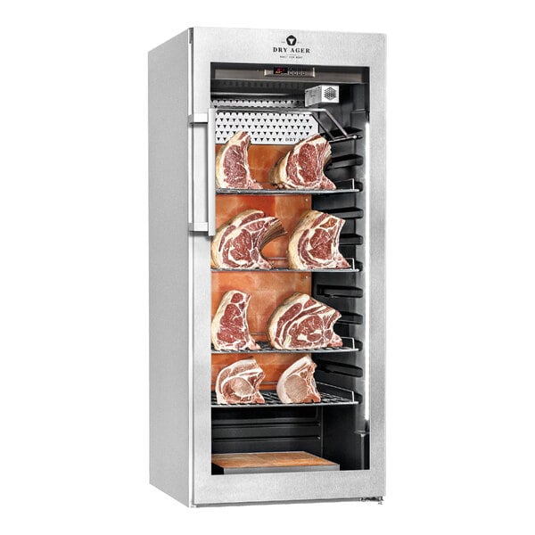 A stainless steel meat curing cabinet with multiple shelves holding large cuts of meat and a backlit salt wall system.