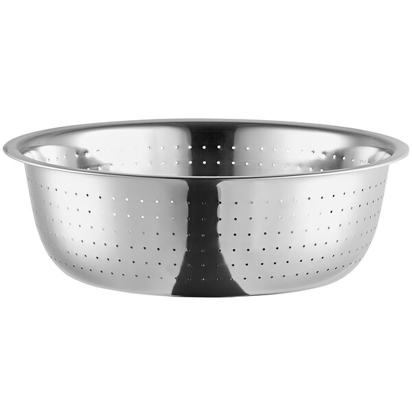 A large stainless steel colander with fine perforations for draining foods.