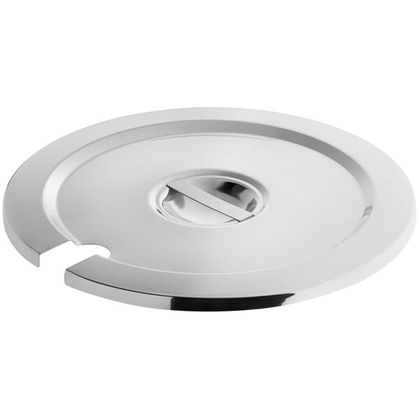 A round, notched stainless steel vegetable inset cover with a central handle.