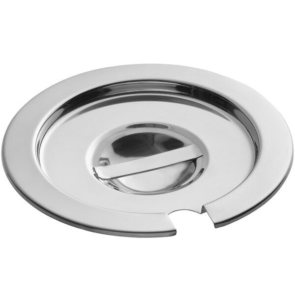 A round, notched stainless steel vegetable inset cover with a central handle.