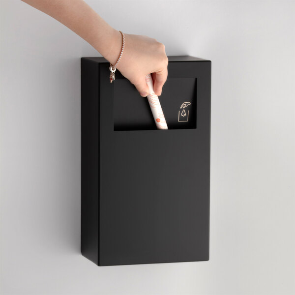 A matte black surface-mounted sanitary napkin disposal unit.