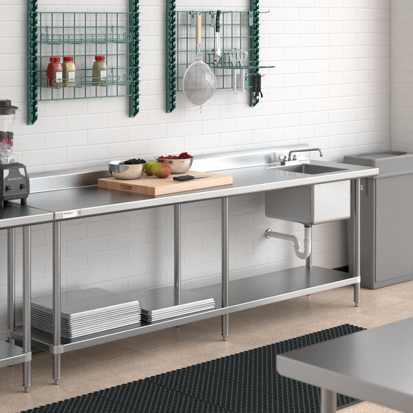 A stainless steel work table with an integrated right-side sink and an undershelf.