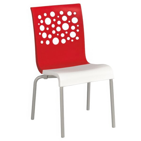 A red and white Grosfillex Tempo stacking chair with white circles on the back.