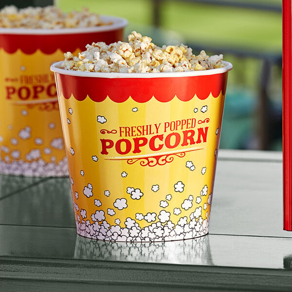 A large bucket of popcorn on a table