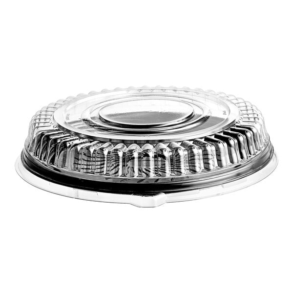 A clear, round, ribbed plastic dome lid placed on a flat surface.