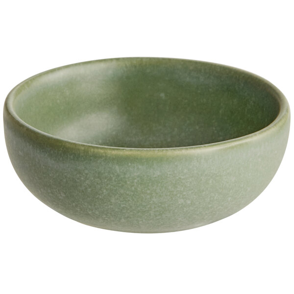A small, round bowl with a matte sage green finish.