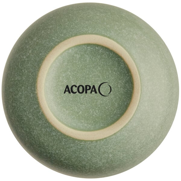 The image shows the bottom view of a small, round, sage green bowl with a matte finish and the brand name 'ACOPA' printed on the base.