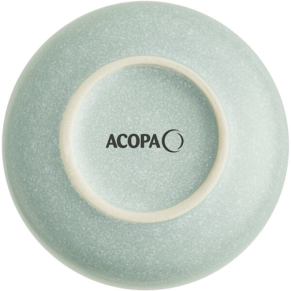 The image shows the bottom view of a small, round, blue-gray dish with a matte finish and the word 'ACOPA' printed on the base.