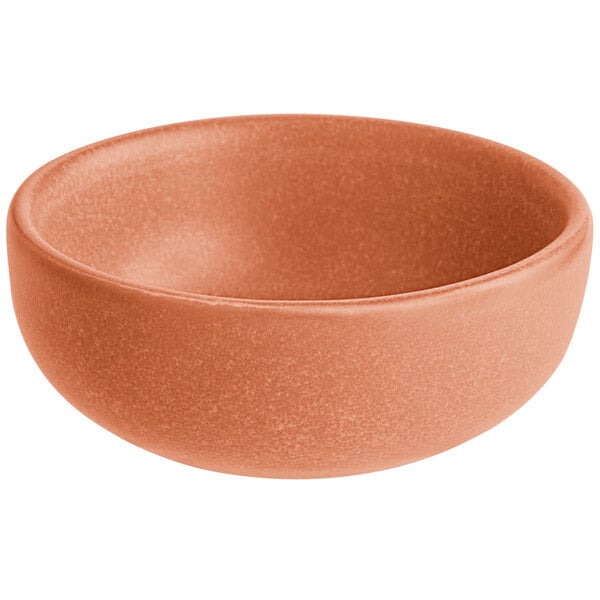 A small, round, terra cotta-colored bowl with a matte finish.