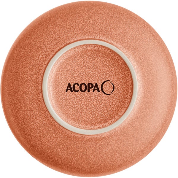 The image shows the underside of a round, terra cotta-colored bowl with a matte, speckled finish and the word 'ACOPA' printed in the center.