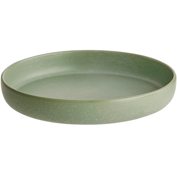 A round, shallow bowl with a matte sage green finish.