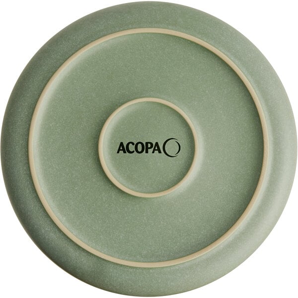 A round, sage green bowl with a matte finish and concentric raised rings, featuring the word 'ACOPA' printed in black at the center.