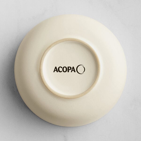 A cream-colored dish shown upside down with the brand name 'ACOPA' printed on the bottom.