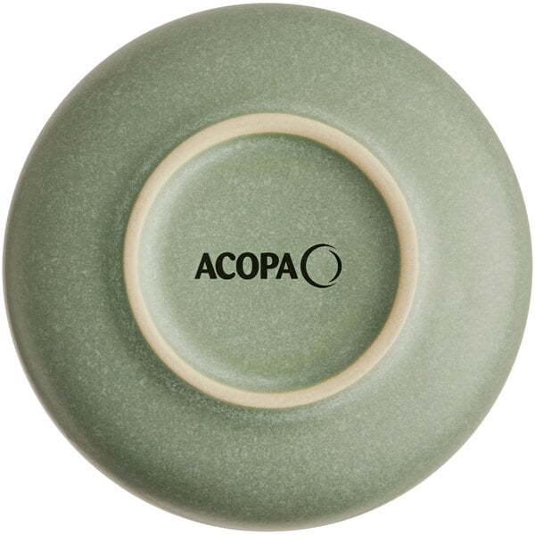The image shows the underside of a sage green bowl with a matte finish and the word 'ACOPA' printed on the base.